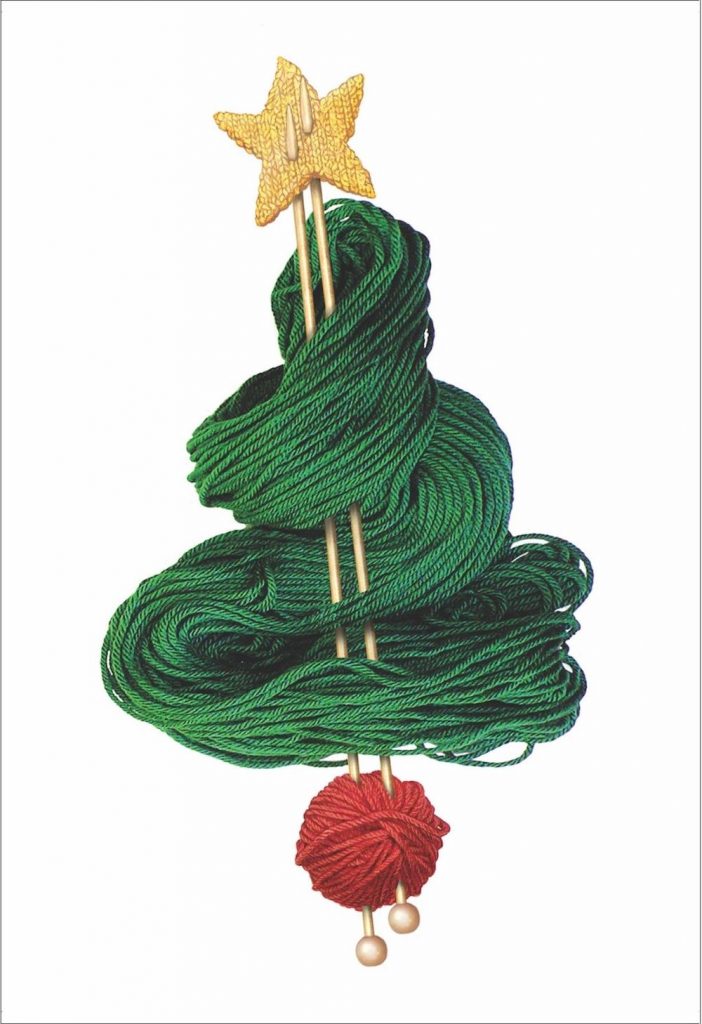 A rectangular Christmas card of a pair of knitting needles on a white background. Around the knitting needles is laid out green yarn in the shape of a Christmas tree, with a ball of red yarn at the bottom and a yellow knitted star at the top.