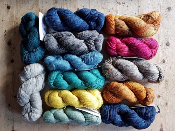 A raffle prize consisting of 13 skeins of yarn from the Yarn Collective